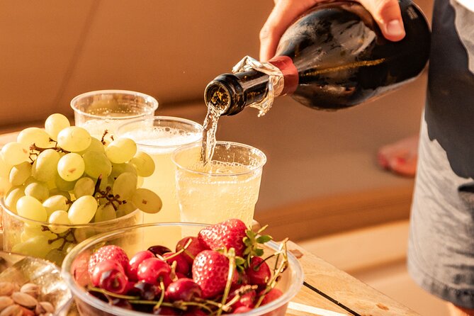 Aperitif on a boat at sunset in the Gulf of Naples - Villa Rosebery from the Gulf