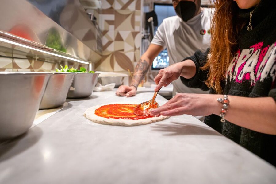 Naples: Authentic Neapolitan Pizza Making Class - Stretching and topping your own pizza