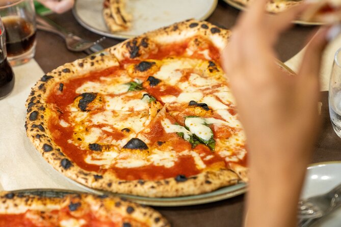 Naples Pizza & Drinks Tour: A Slice of Naples with Eating Europe - Port’Alba: beginning among books and old city gates