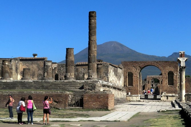 Temple columns in the Pompeii forum with Vesuvius behind them