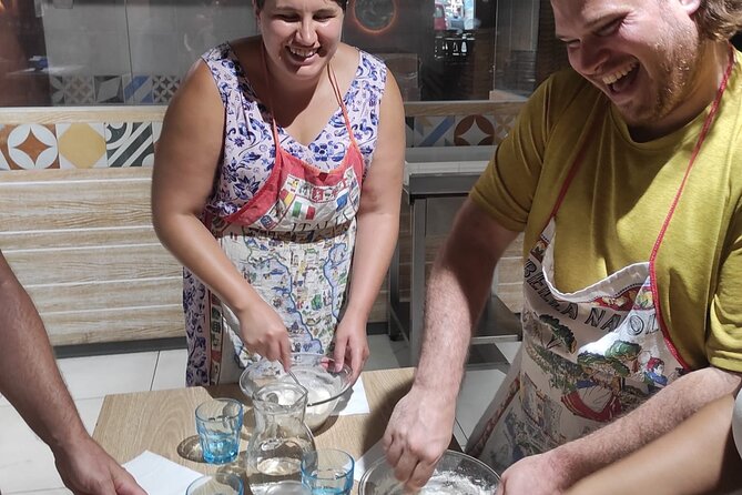 Semi-Private Pizza Making Experience in Naples with Drink - Stretching, topping, and loading the pizza